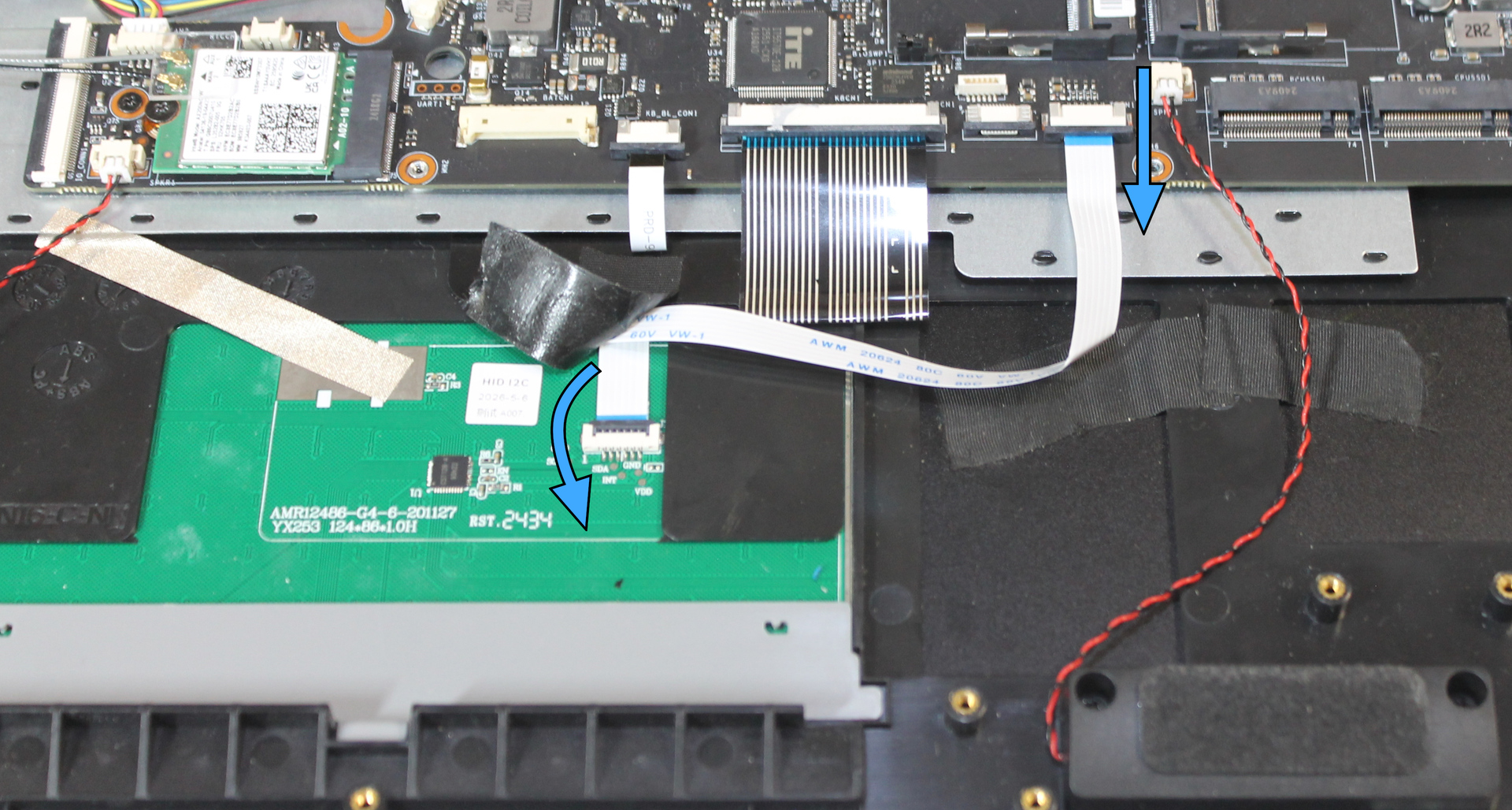 Touchpad cable connectors, with movement directions indicated to release each